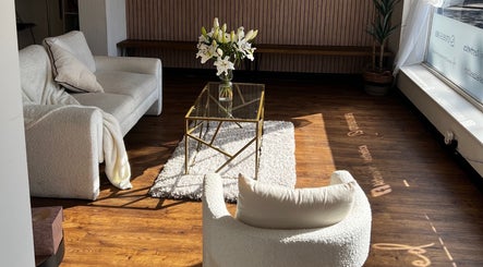 Cozy seating area with flowers at Airbrushed Aesthetics, Spalding, England, GB.