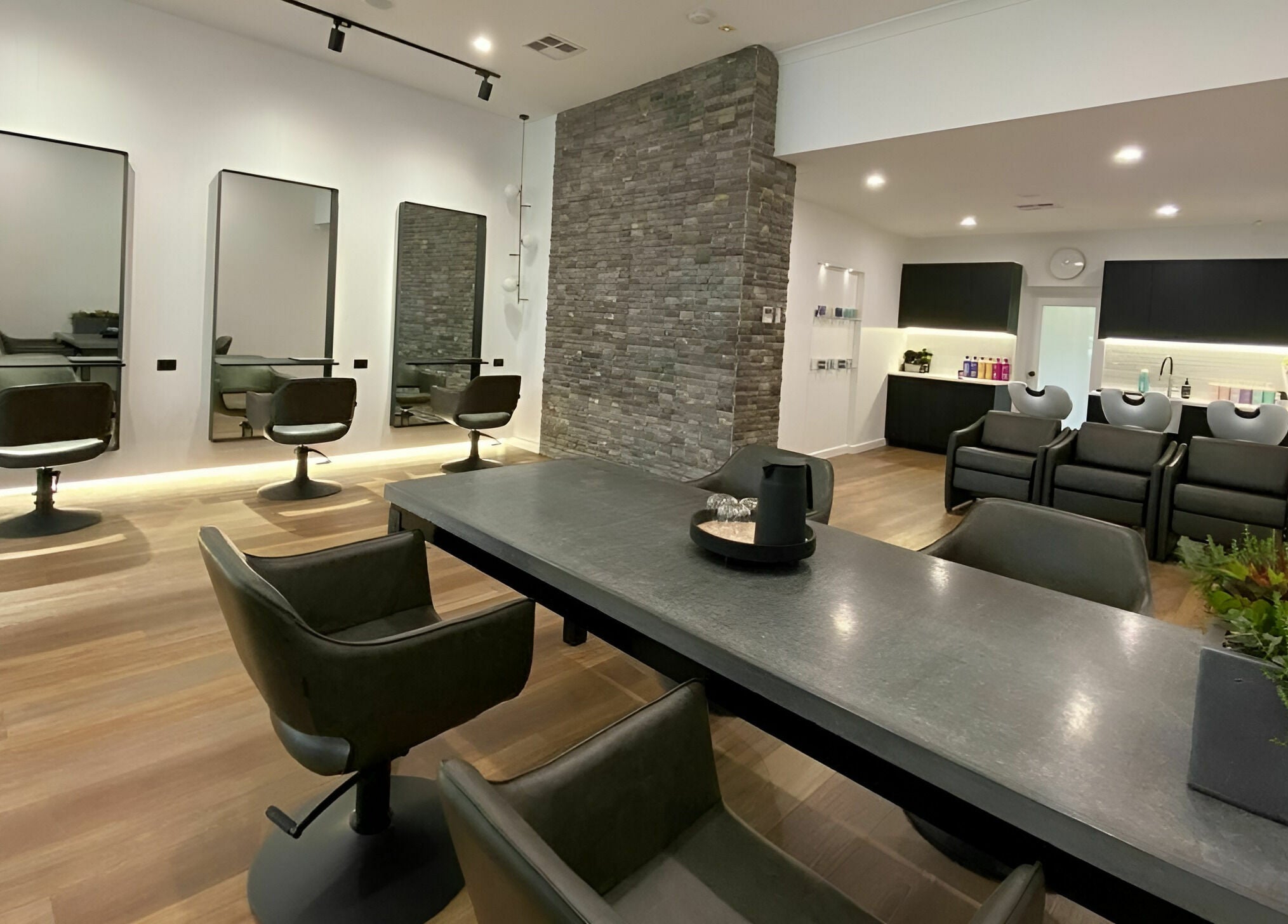 Modern salon interior at NUHAIRCO in Mount Claremont, AU, featuring sleek styling chairs and elegant décor.
