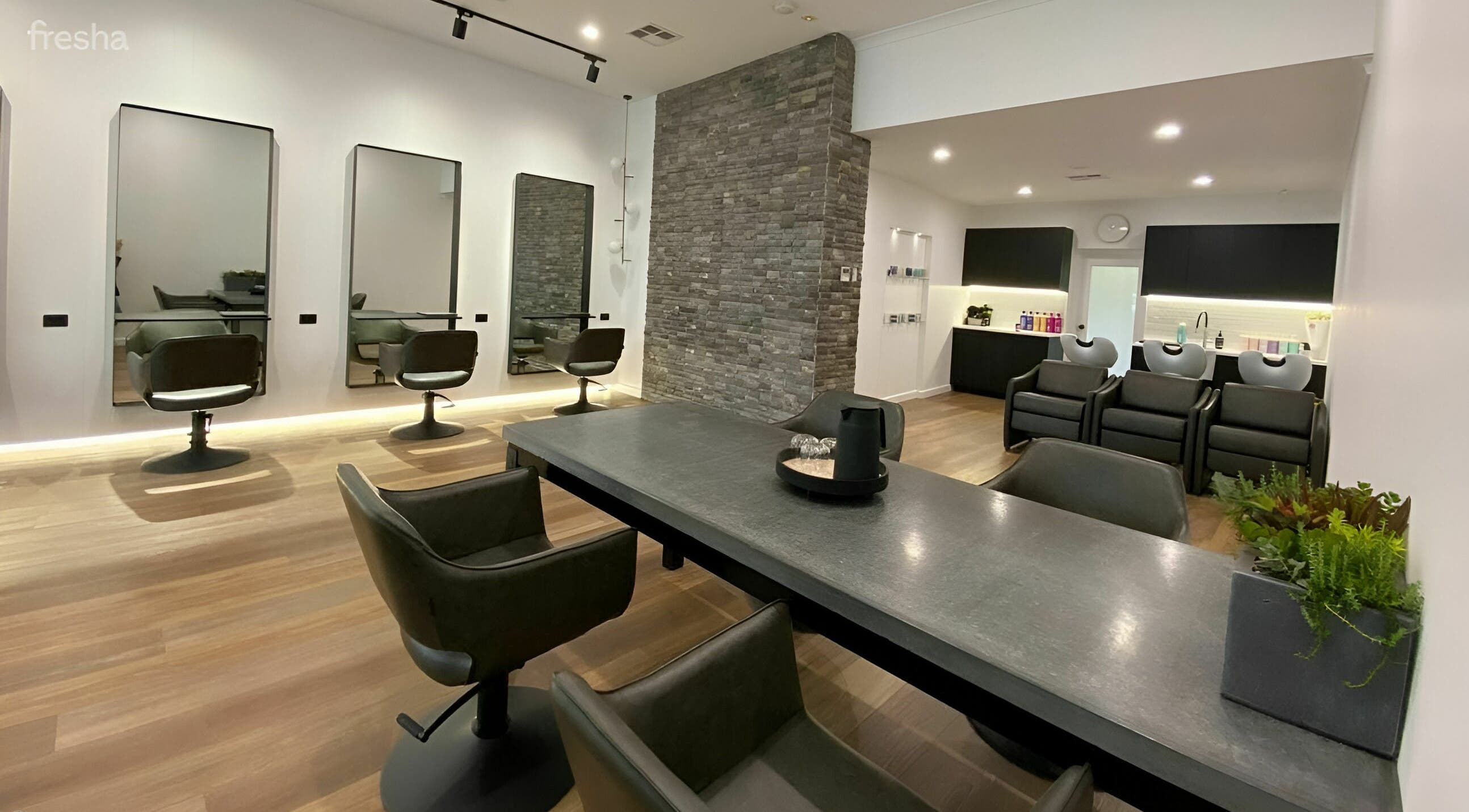 Modern salon interior at NUHAIRCO in Mount Claremont, AU, featuring sleek styling chairs and elegant décor.