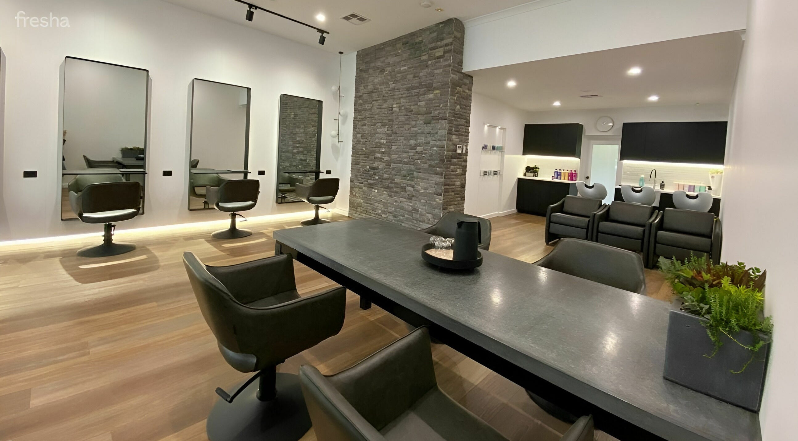 Modern salon interior at NUHAIRCO in Mount Claremont, AU, featuring sleek styling chairs and elegant décor.