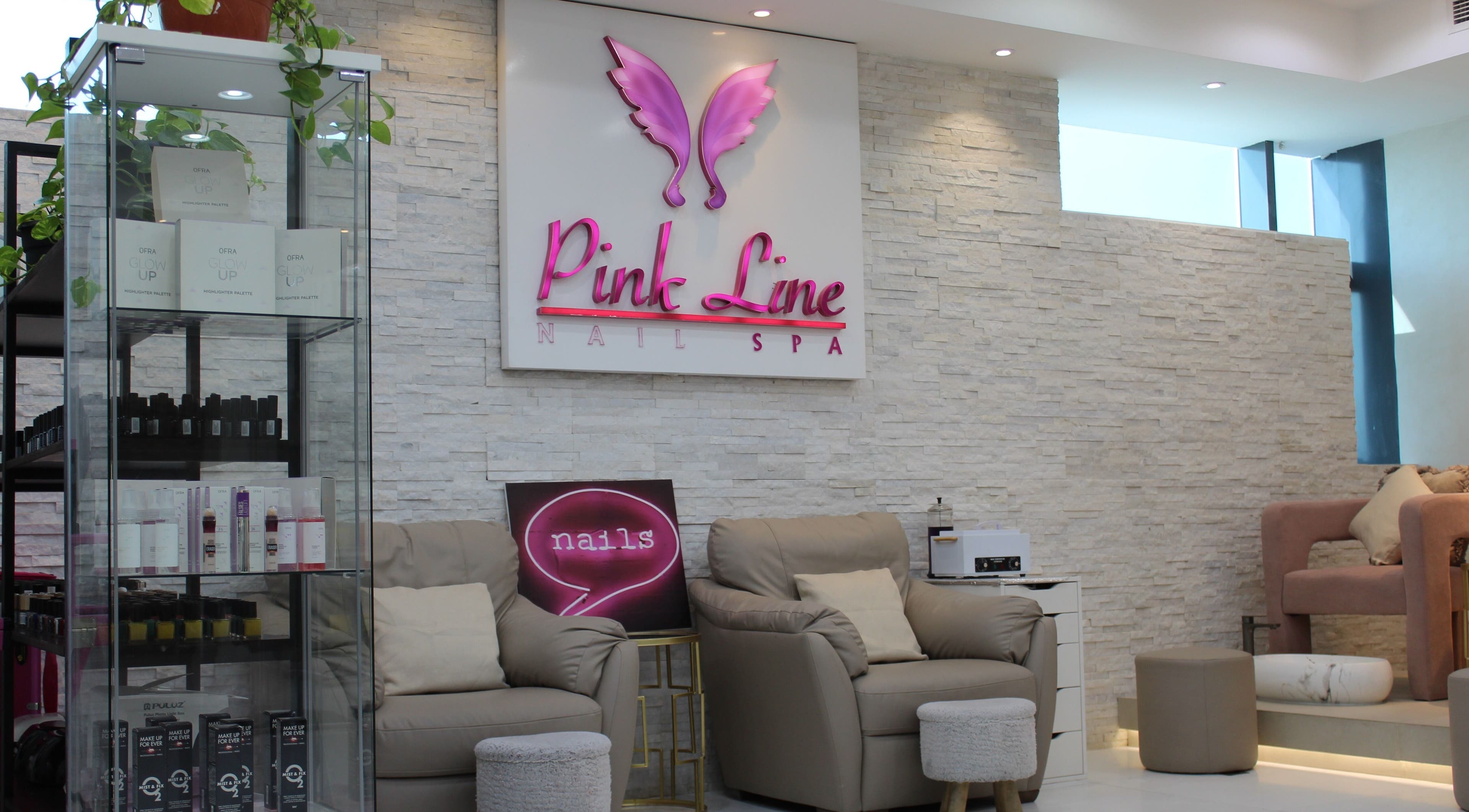 Elegant interior of Pink Line Beauty Salon in دبي, دبي, AE with plush seating and beauty product display.