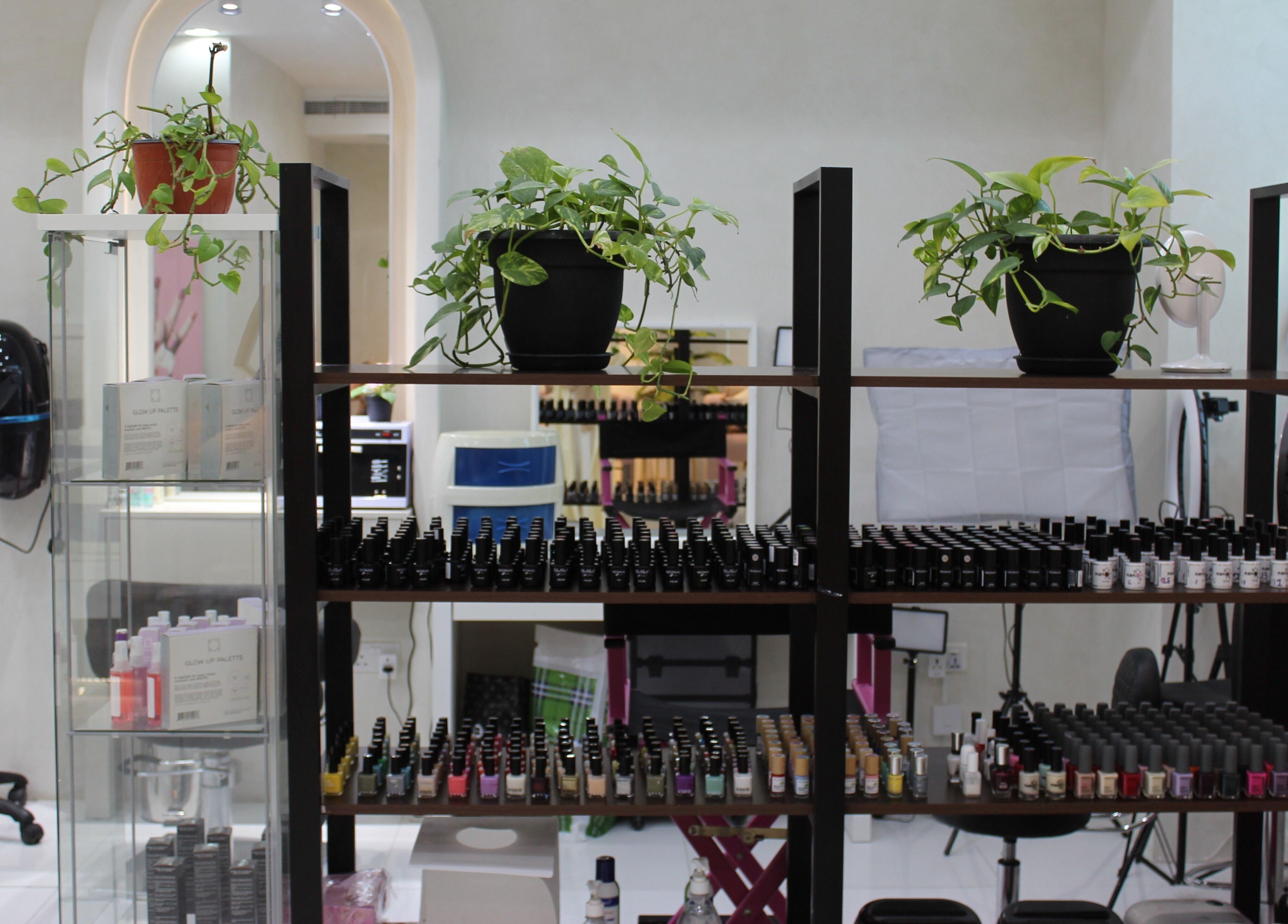 Nail polish and greenery display at Pink Line Beauty Salon in دبي, دبي, AE showcasing vibrant colors.