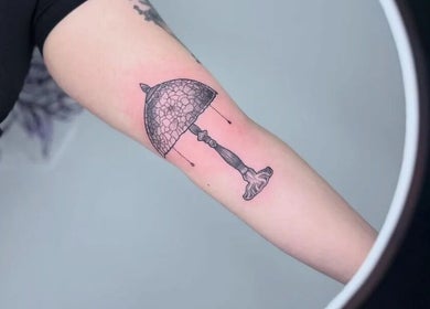 Unique umbrella tattoo design showcased at Anubis Piercings and Laser Tattoo Removal, Ashby-de-la-zouch, England, GB.