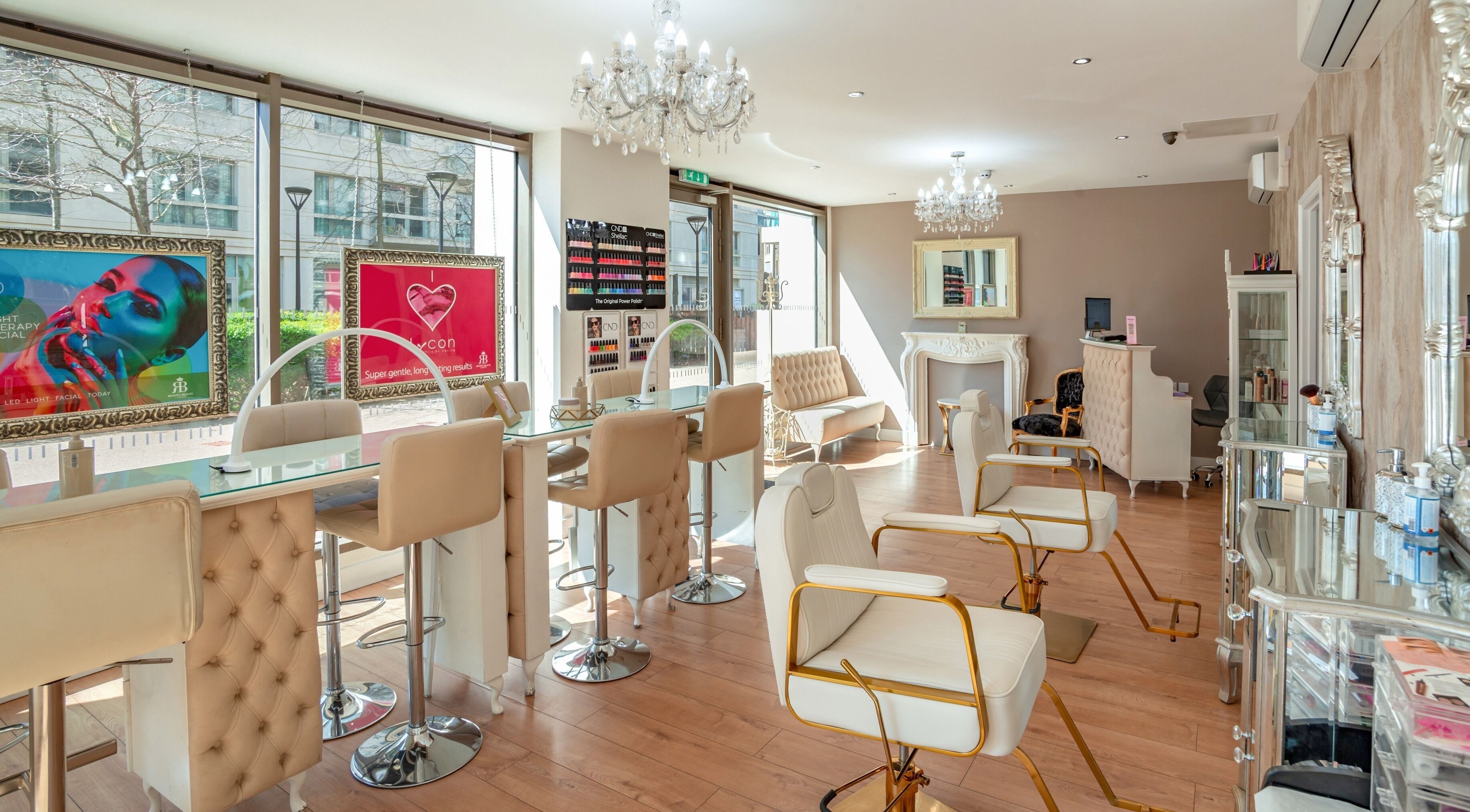 Elegant beauty salon interior at Regency Beauty London, London, England, GB with chic seating and chandeliers.