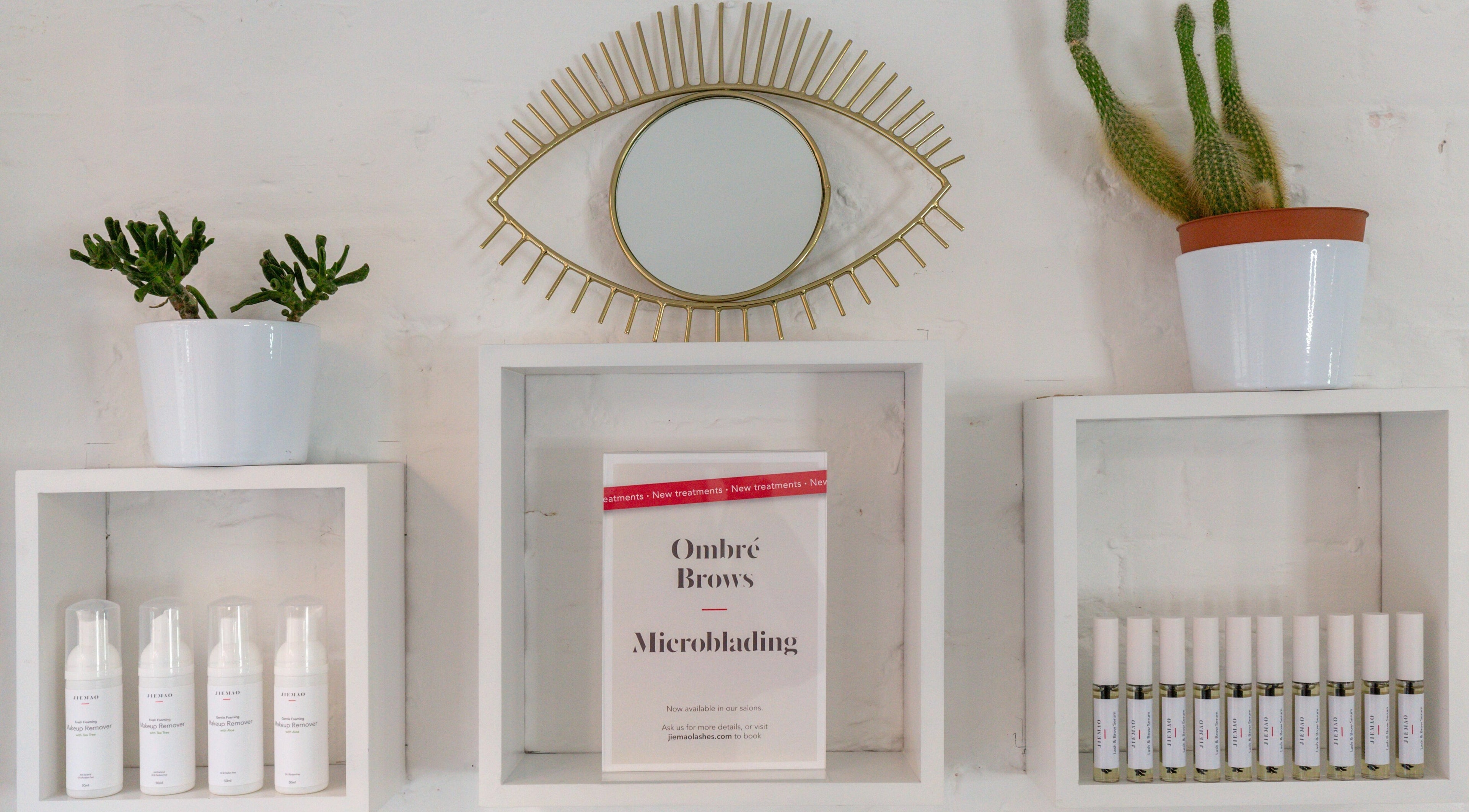 Stylish wall decor at Jiemao Lashes & Brows Shoreditch, London, England, GB showcasing beauty products.