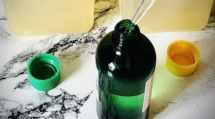 A green bottle with pipette at Emerald Touch Massage, York, England, GB, used for soothing wellness treatments.