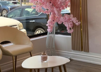 Elegant seating area with pink blossoms at St. Catharines / R. Luxury Nails & Beauty, St. Catharines, Ontario, CA.