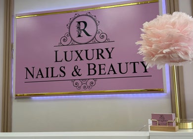 Elegant interior sign of R. Luxury Nails & Beauty, St. Catharines, Ontario, CA with pink decor.
