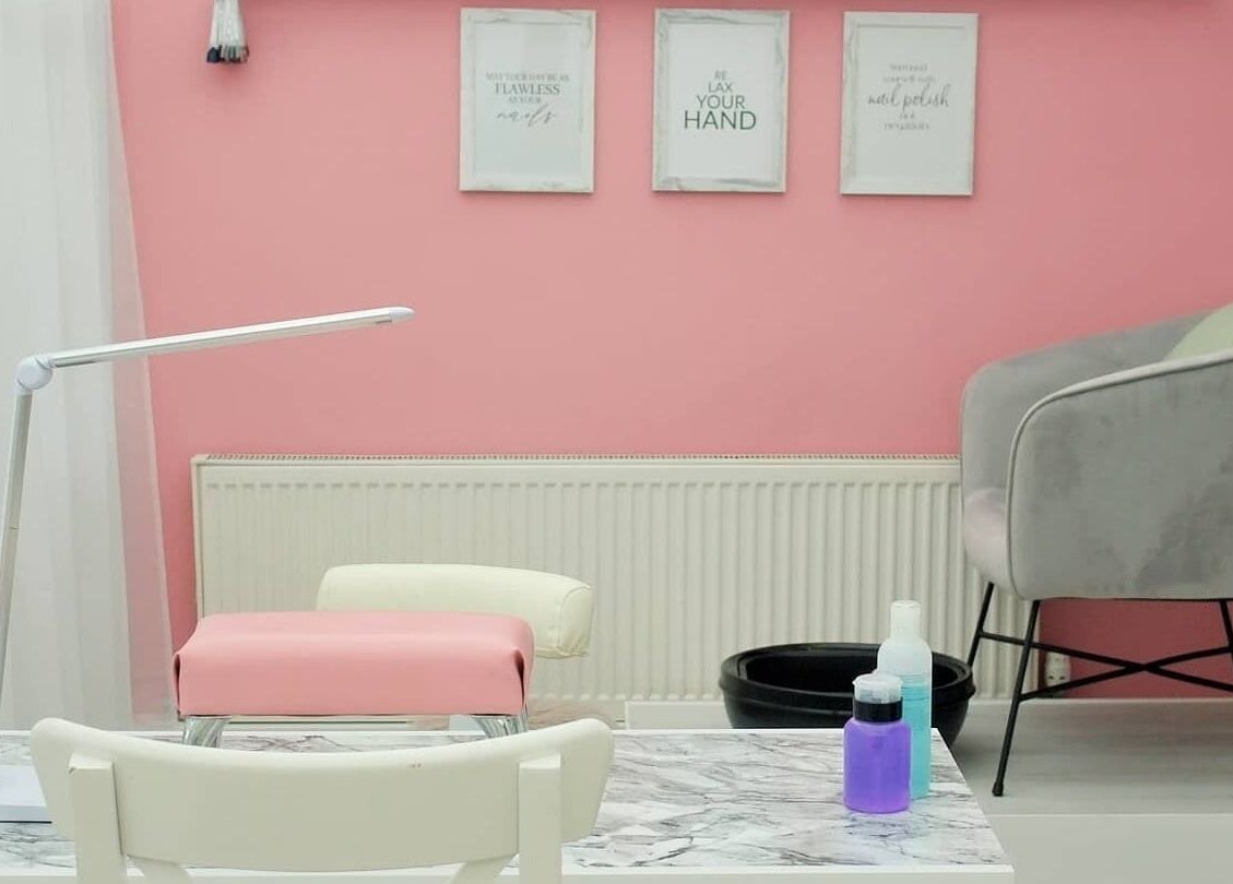Chic nail salon interior at Pro Radiance in Havant, England, GB with pink walls and stylish decor.