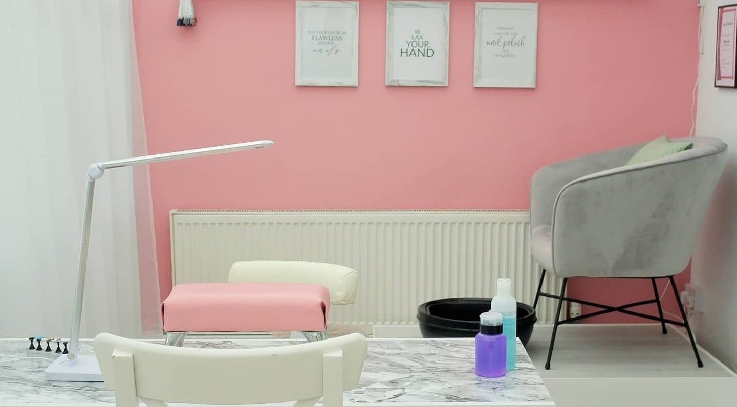 Chic nail salon interior at Pro Radiance in Havant, England, GB with pink walls and stylish decor.