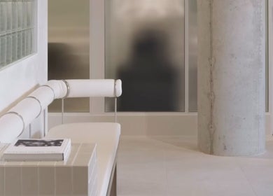 Sleek interior of SJ Hair Collective in Innaloo, Western Australia, AU, featuring modern white seating and decor.