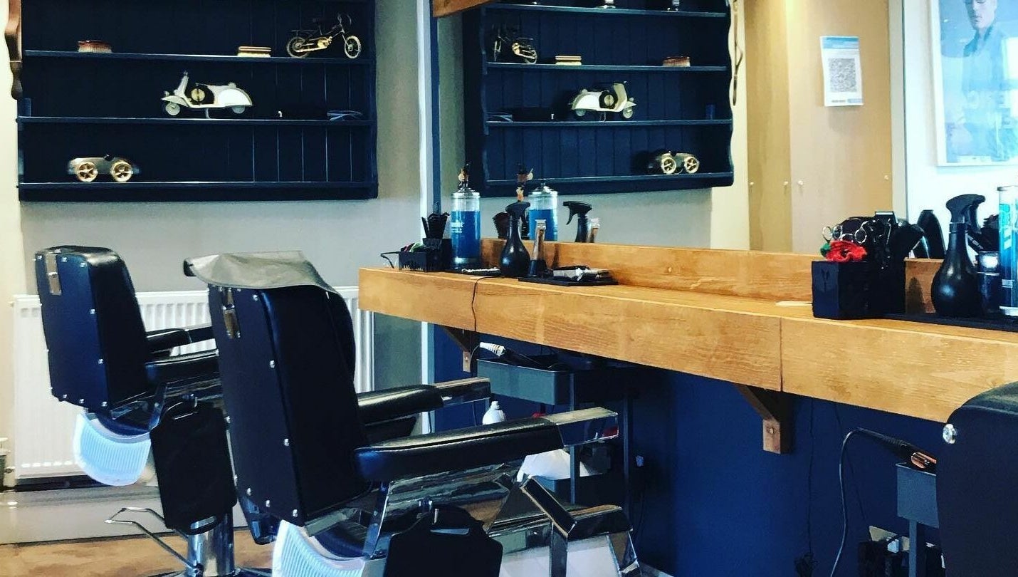 Elegant interior of Clippers for Men in Southam, England, GB featuring classic barber chairs and vintage decor.