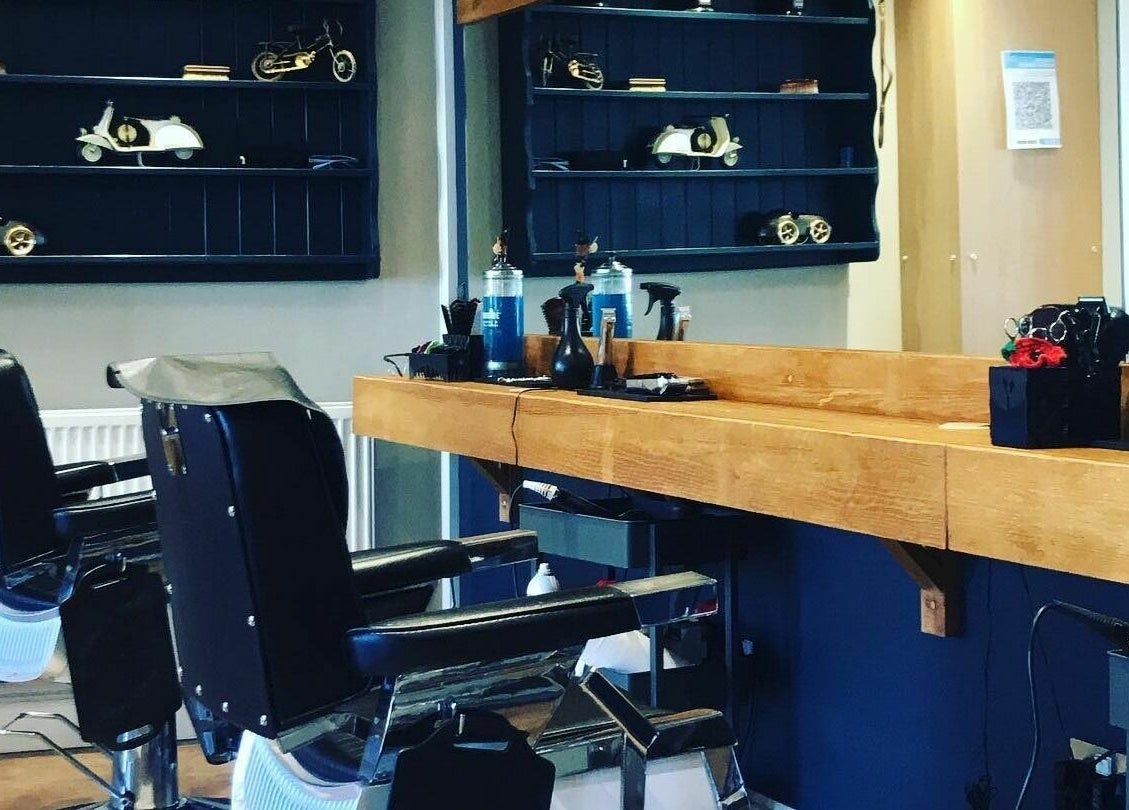 Elegant interior of Clippers for Men in Southam, England, GB featuring classic barber chairs and vintage decor.