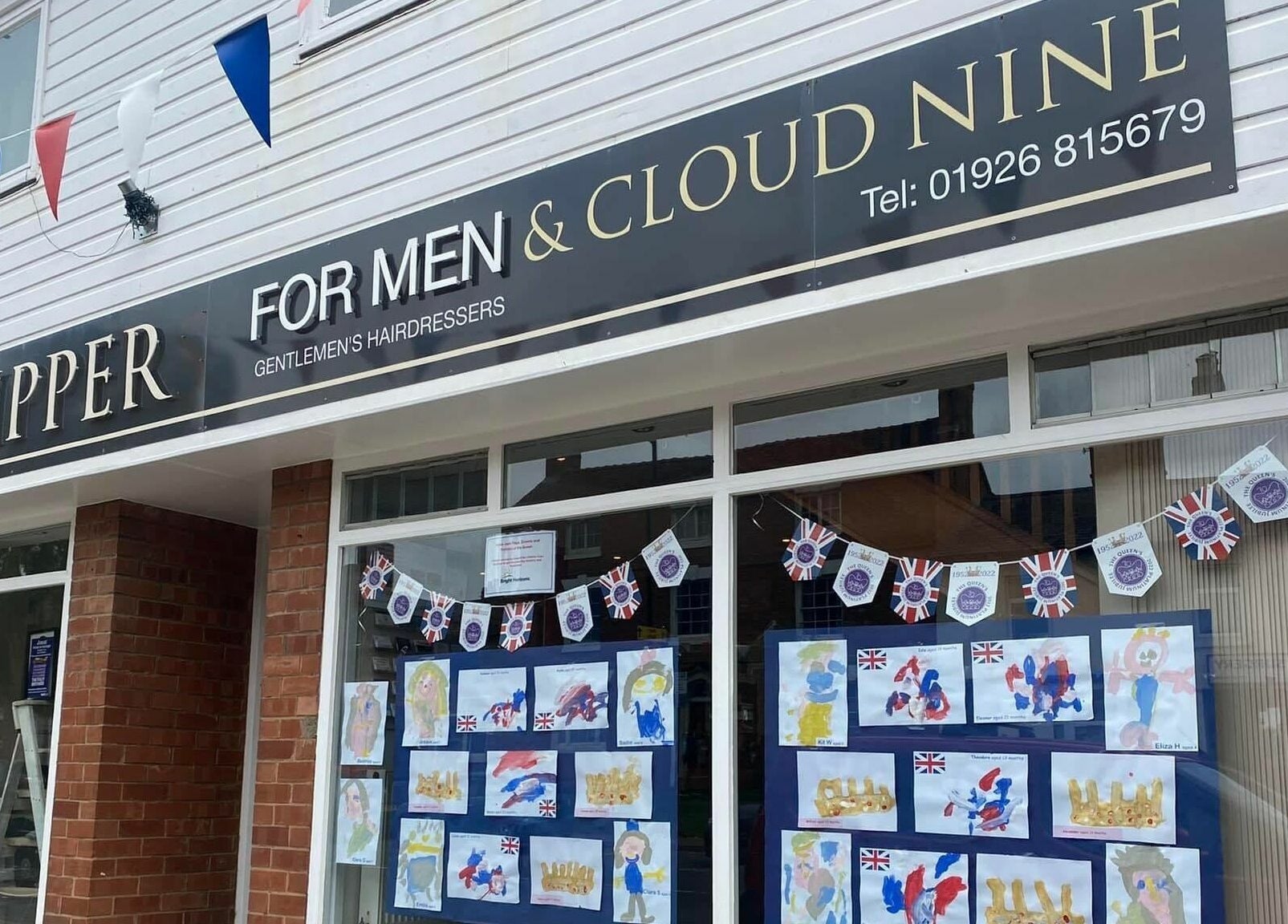 Clippers for Men storefront in Southam, England, GB, featuring creative window displays.