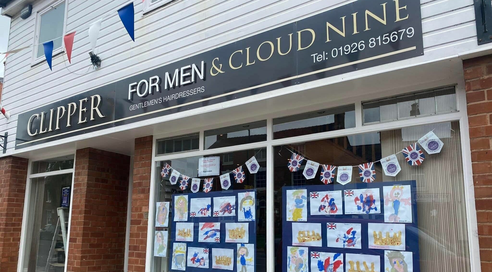 Clippers for Men storefront in Southam, England, GB, featuring creative window displays.