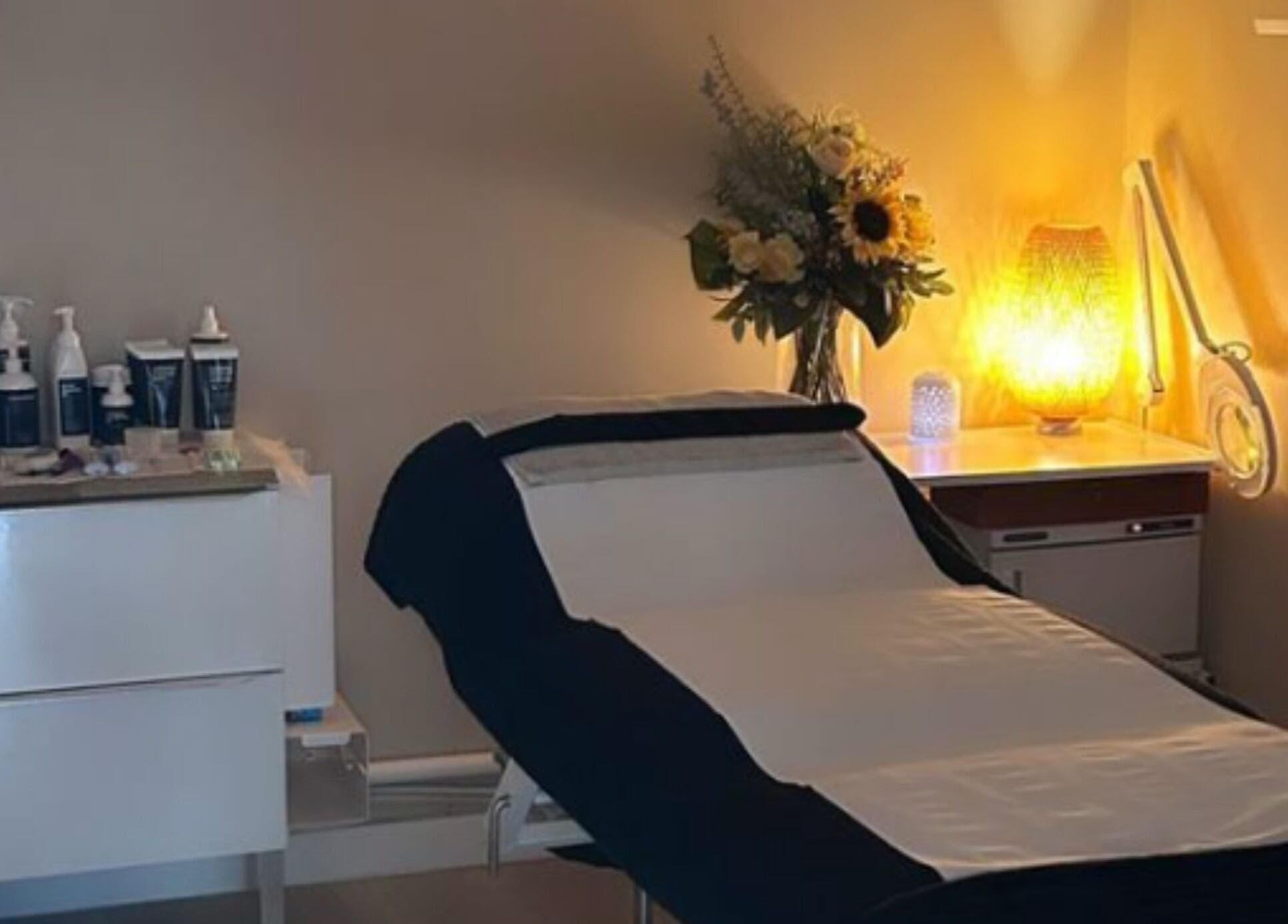 Relaxing treatment room at Revitalize Beauty and Aesthetics, Westgate-on-Sea, England, GB with ambient lighting.