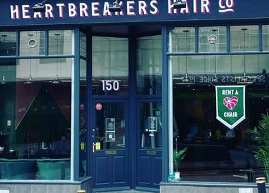 Main entrance of Lauren Wingfield at Heartbreakers, Exeter, England, GB with neon heart sign.