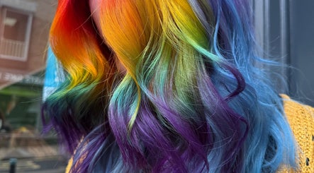 Vibrant rainbow hair color at Lauren Wingfield at Heartbreakers, Exeter, England, GB showcasing creative styling.