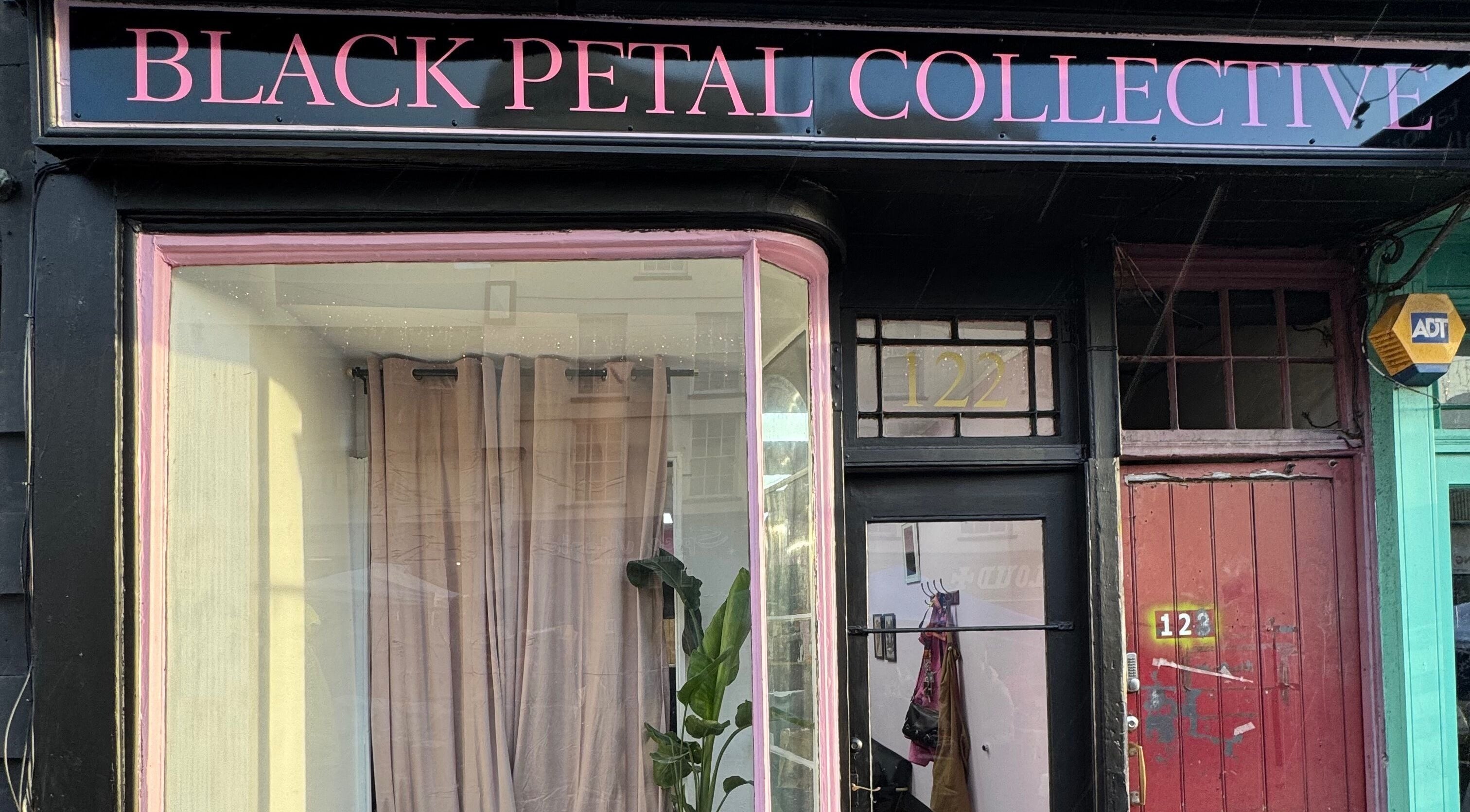 Exterior view of Lauren at Black Petal Collective in Exeter, England, GB. Stylish black and pink storefront design.