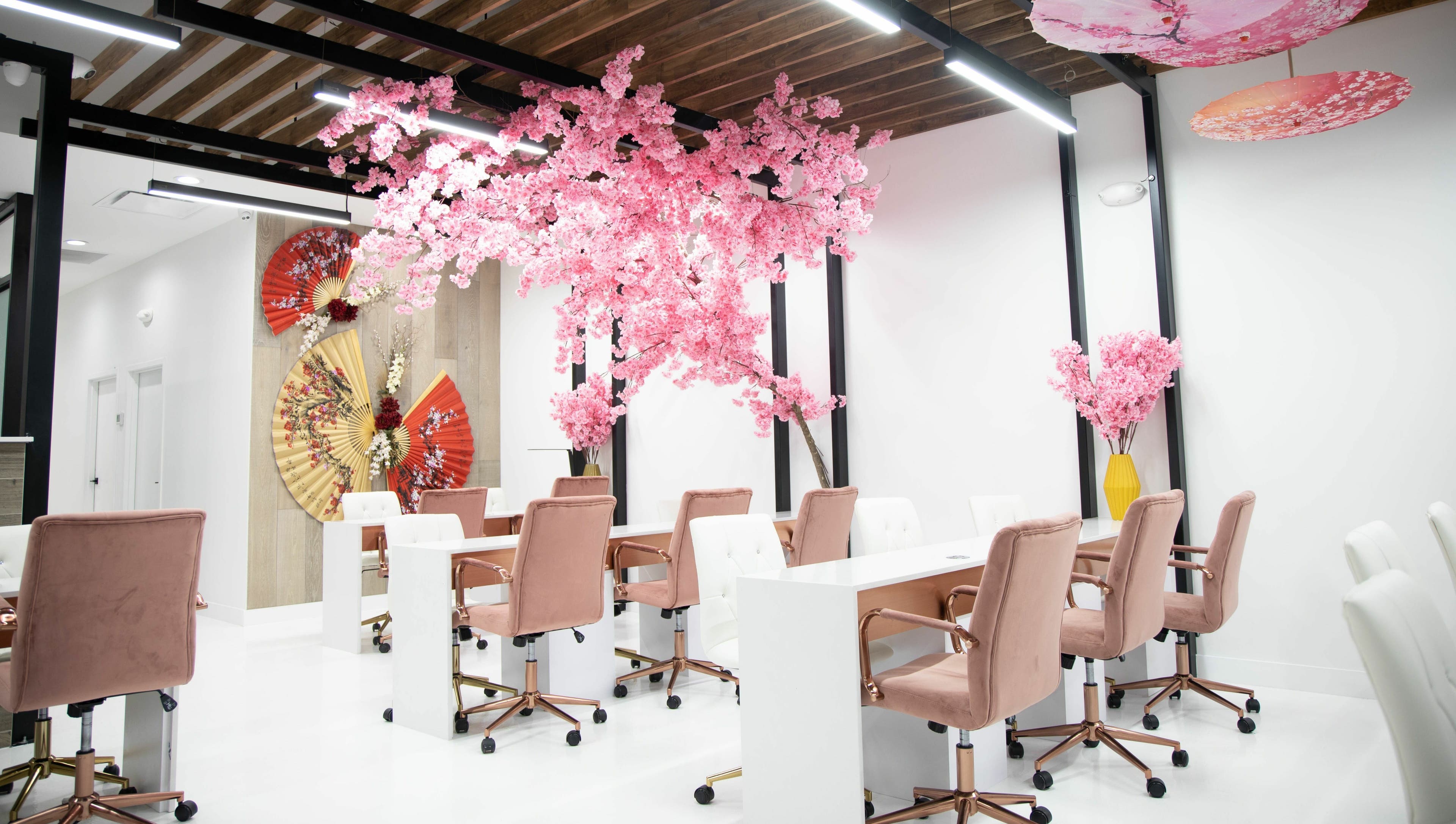 Elegant nail stations with pink blossoms at Raizun Nail Spa, Fairfax, Virginia, US.