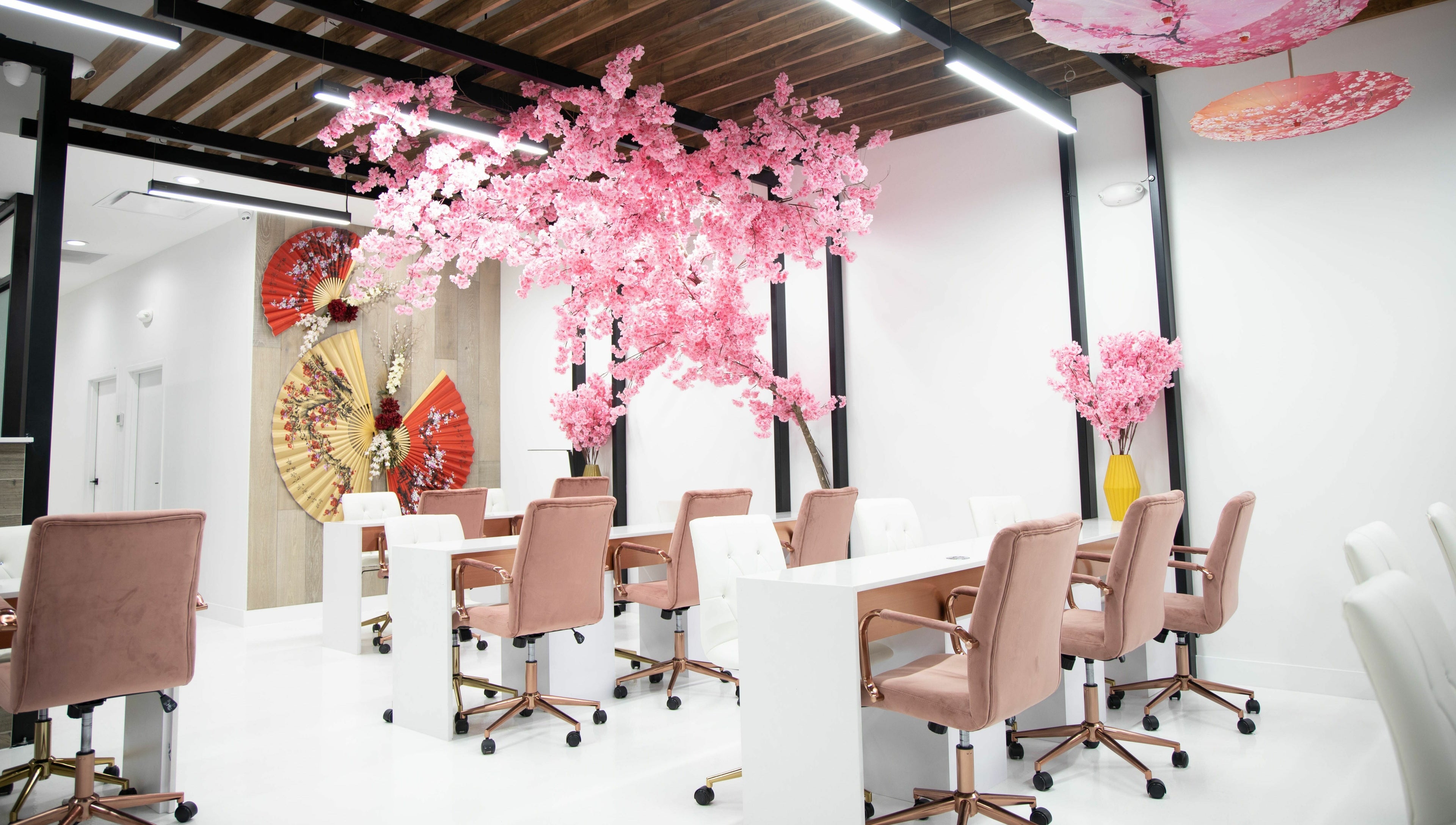Elegant nail stations with pink blossoms at Raizun Nail Spa, Fairfax, Virginia, US.