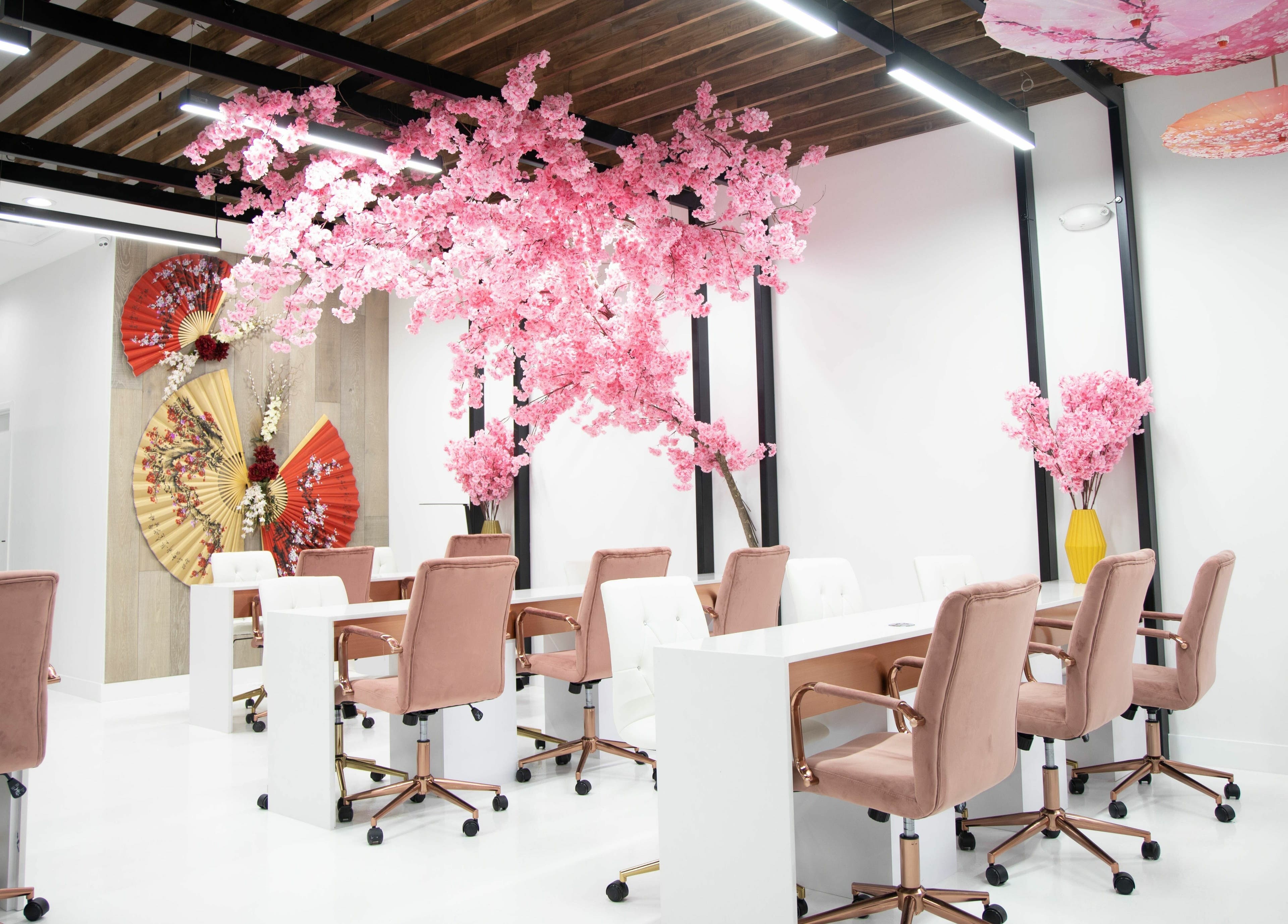 Elegant nail stations with pink blossoms at Raizun Nail Spa, Fairfax, Virginia, US.