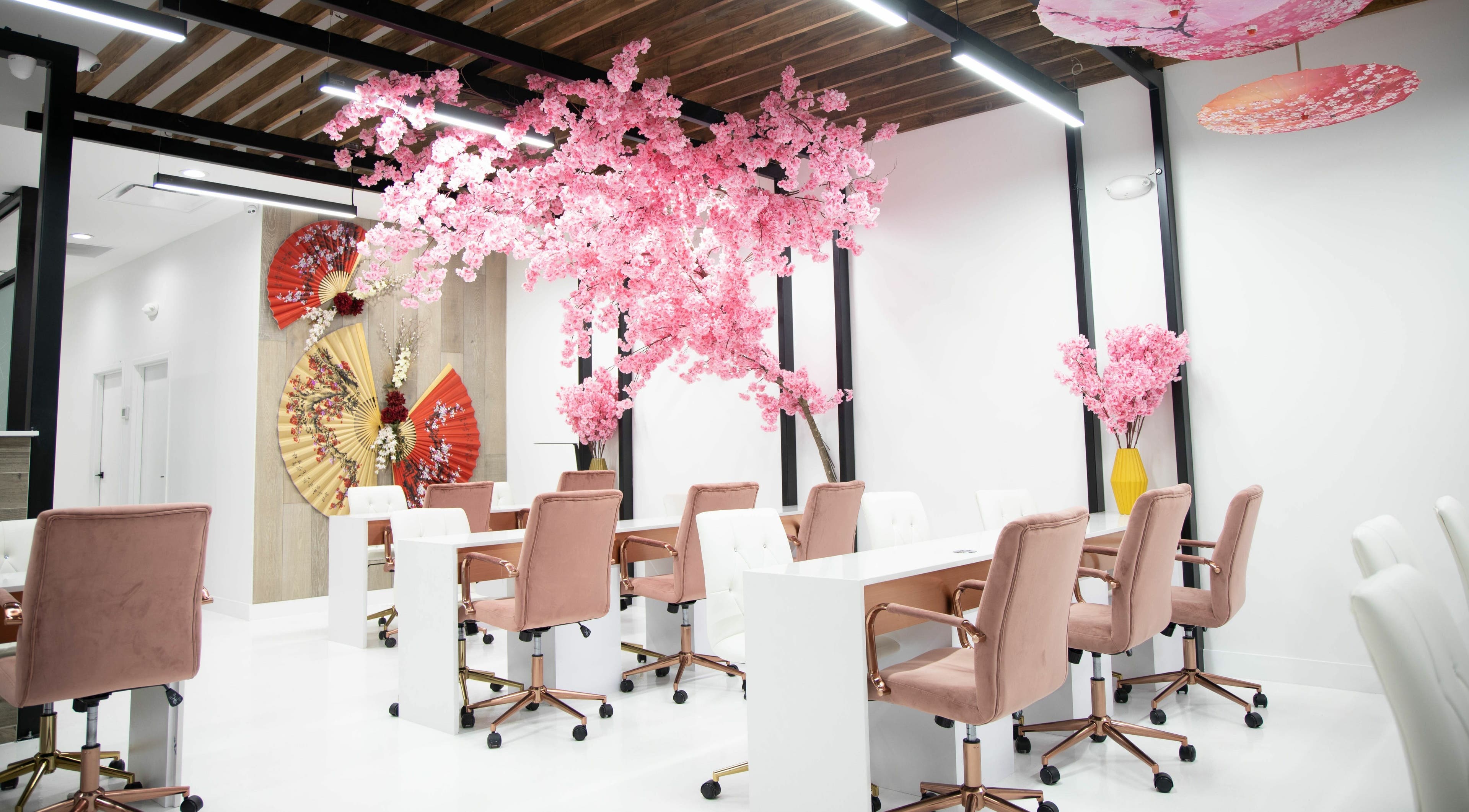 Elegant nail stations with pink blossoms at Raizun Nail Spa, Fairfax, Virginia, US.