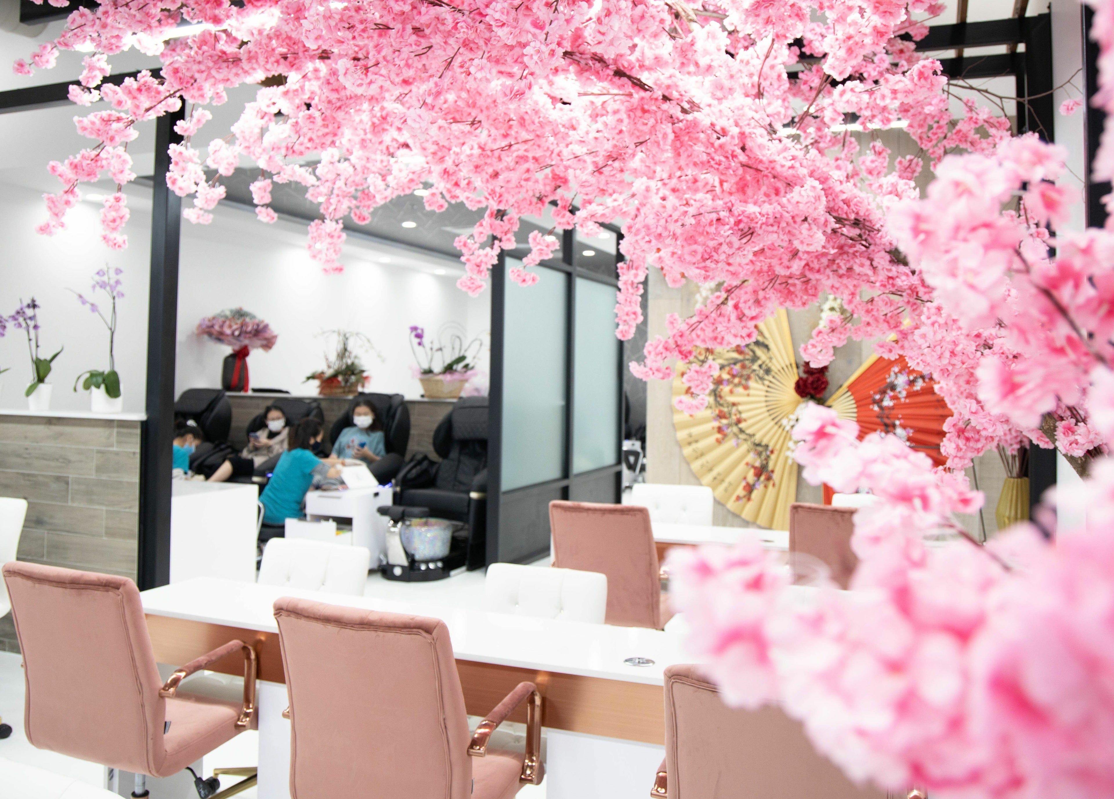 Lush cherry blossoms adorn Raizun Nail Spa in Fairfax, Virginia, US, offering a serene beauty experience.