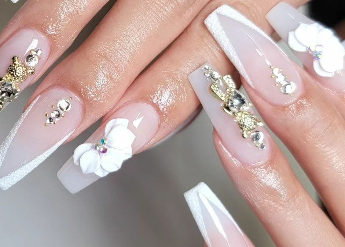 Intricate nail art design at Raizun Nail Spa, Fairfax, Virginia, US with floral and jewel embellishments.