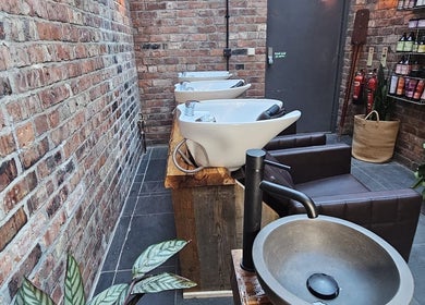 Chic hair wash stations at Evergreen Salon Durham Road, Gateshead, England, GB, showcasing rustic elegance.