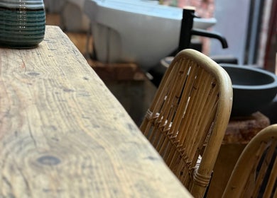Rustic decor at Evergreen Salon Durham Road, Gateshead, England, GB with wooden chairs and pottery.