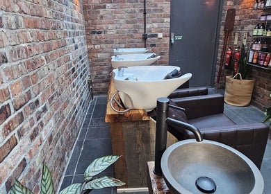 Chic wash stations at Evergreen Salon Durham Road, Gateshead, England, GB. Brick walls add rustic charm.