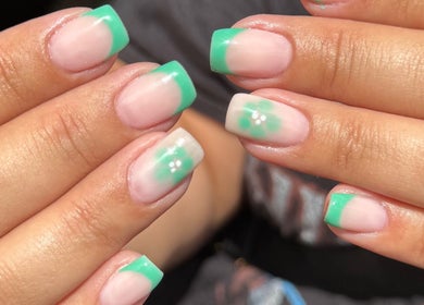Vibrant mint green nail art by Lauren Jeffrey Nails, East Calder, Scotland, GB, featuring delicate floral accents.