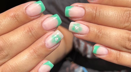 Vibrant mint green nail art by Lauren Jeffrey Nails, East Calder, Scotland, GB, featuring delicate floral accents.