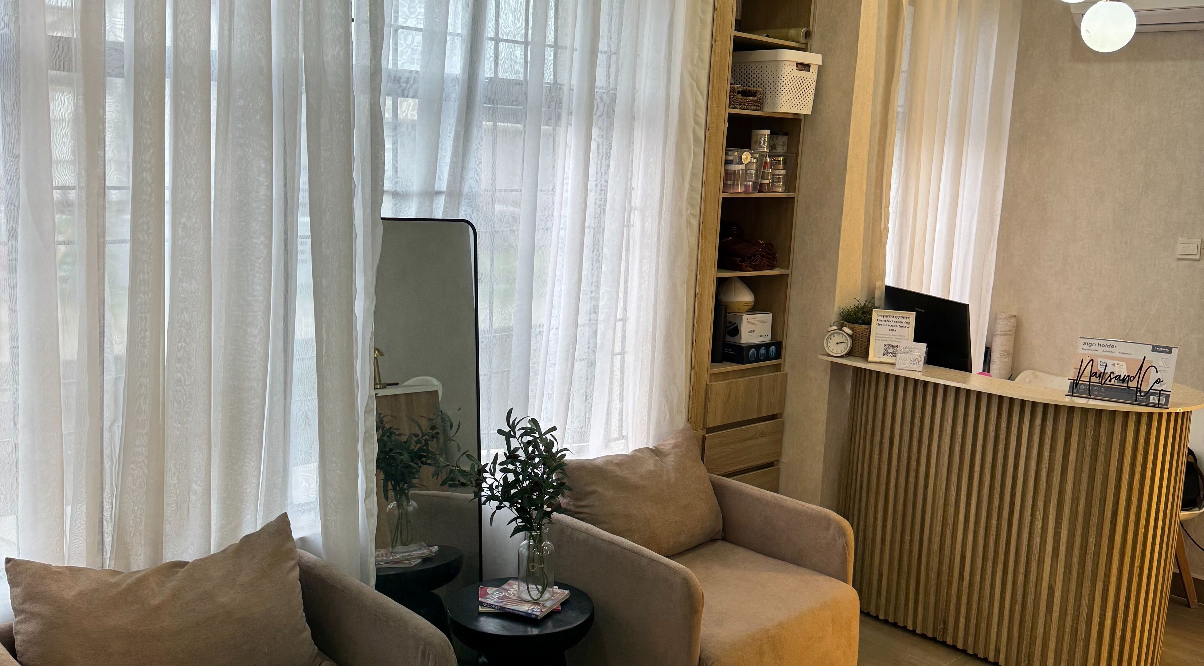 Bright and cozy reception at Nails & Co., Lekki, Lagos, NG with comfortable seating and elegant decor.