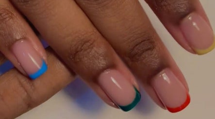 Colorful French manicure at Nails & Co., Lekki, Lagos, NG with vibrant nail tips in blue, green, red, and yellow.
