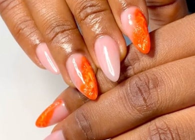 Stylish orange and pink nails from Nails & Co. in Lekki, Lagos, NG showcasing vibrant artistry.