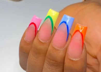 Vibrant rainbow acrylic nails design at Nails & Co., Lekki, Lagos, NG offers stunning nail art.
