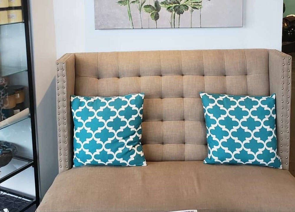 Elegant seating area at Posh Contessa Nails Spa, Burlington, Ontario, CA with stylish pillows and decor.