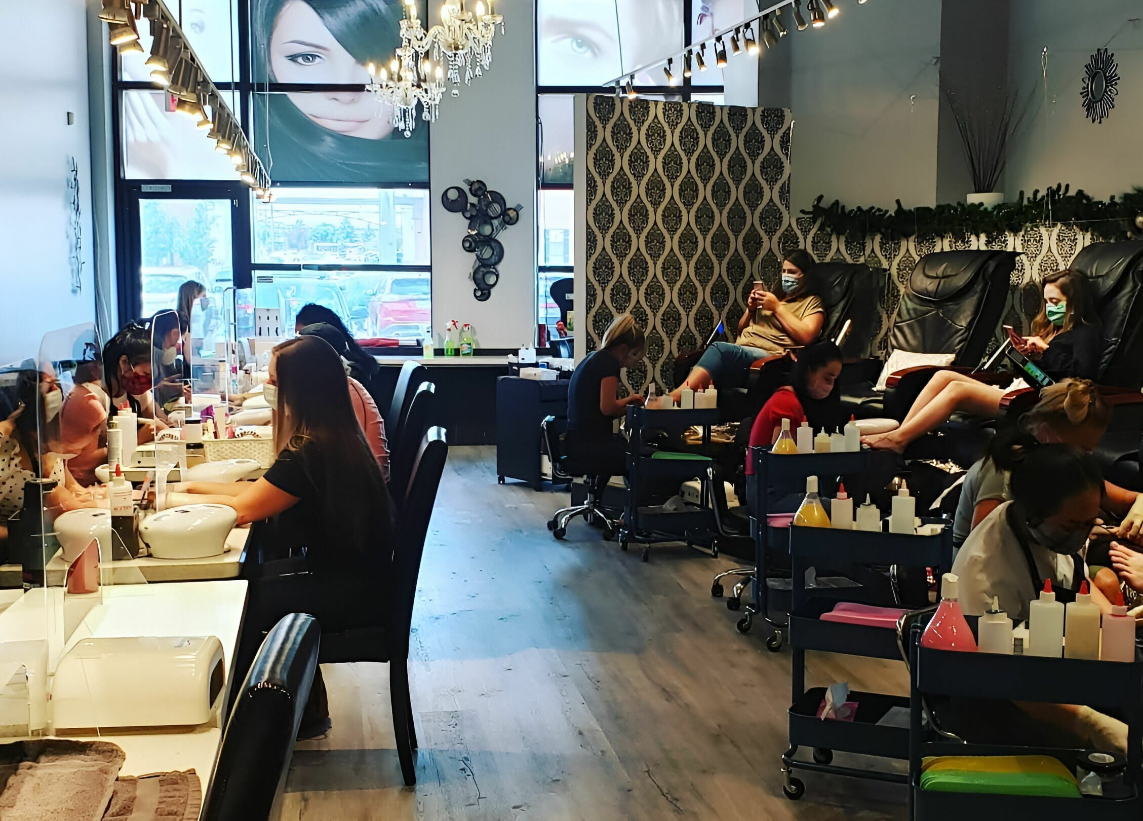 Lively interior of Posh Contessa Nails Spa in Burlington, Ontario, CA with customers enjoying manicures and pedicures.