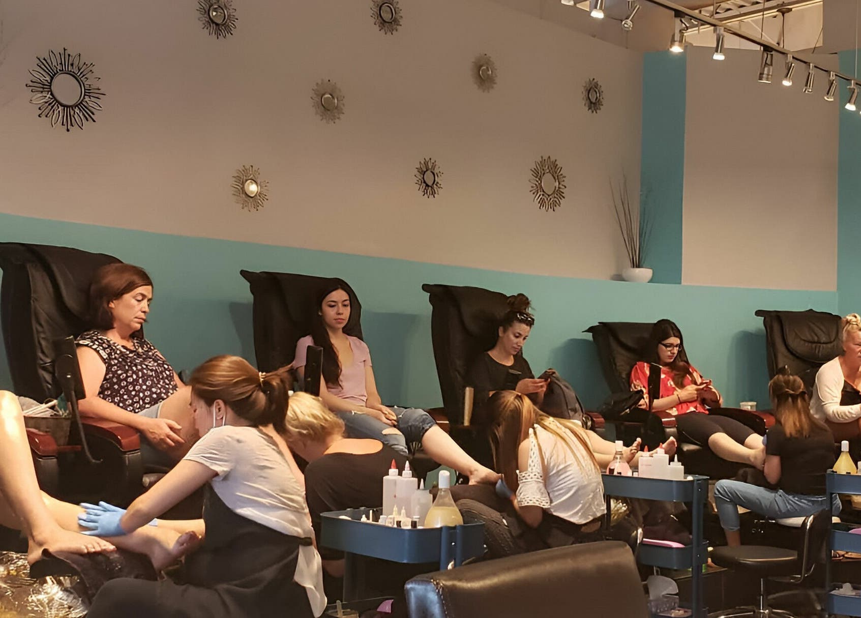 Women getting pedicures at Posh Contessa Nails Spa, Burlington, Ontario, CA in modern, relaxing chairs.