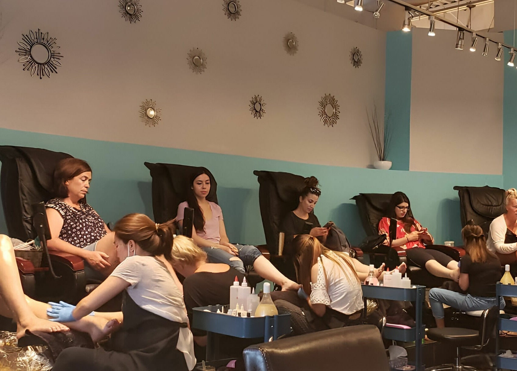 Women getting pedicures at Posh Contessa Nails Spa, Burlington, Ontario, CA in modern, relaxing chairs.