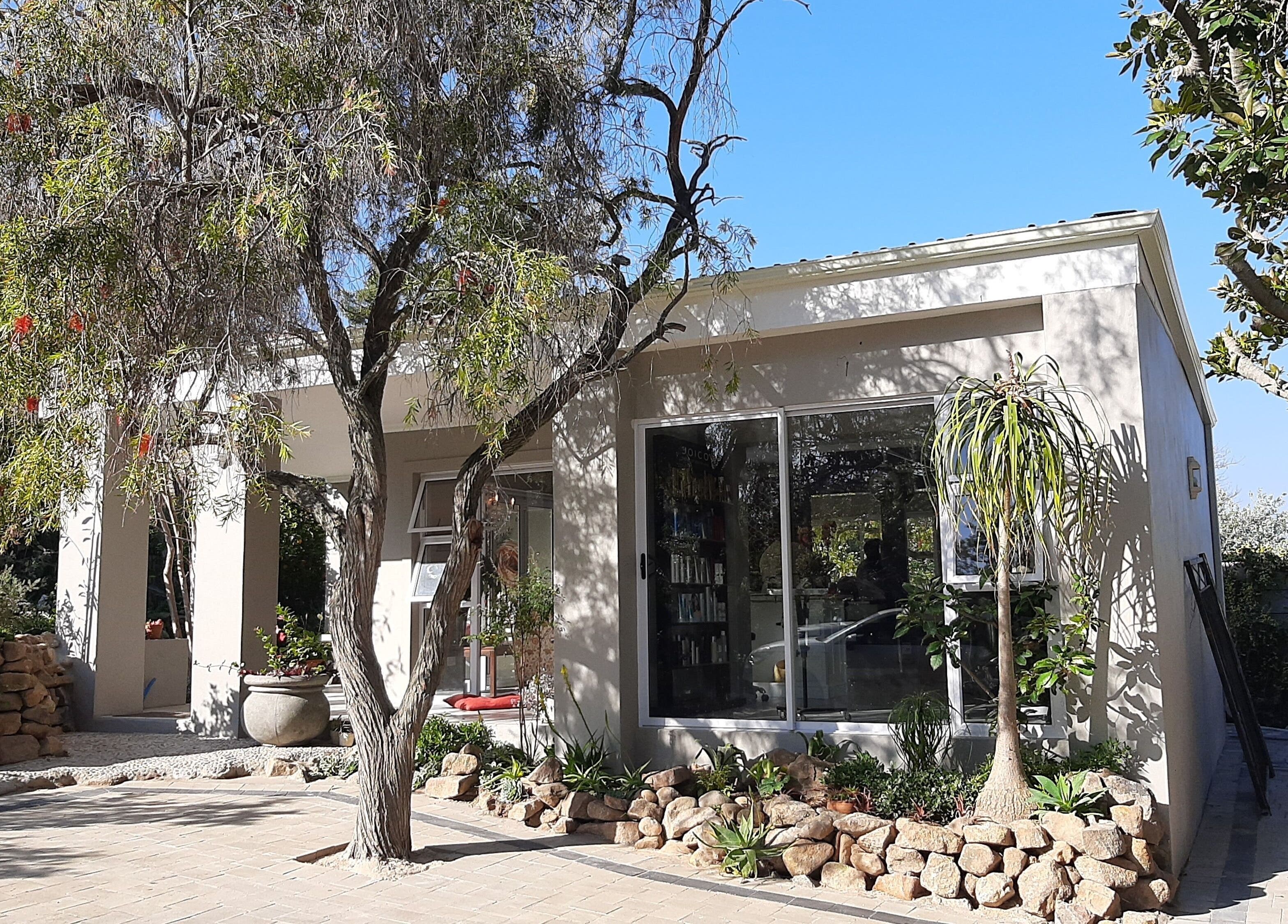 Relaxing exterior of Sherri Styles at 134 Upper Orange, Somerset West, Western Cape, ZA surrounded by lush greenery.