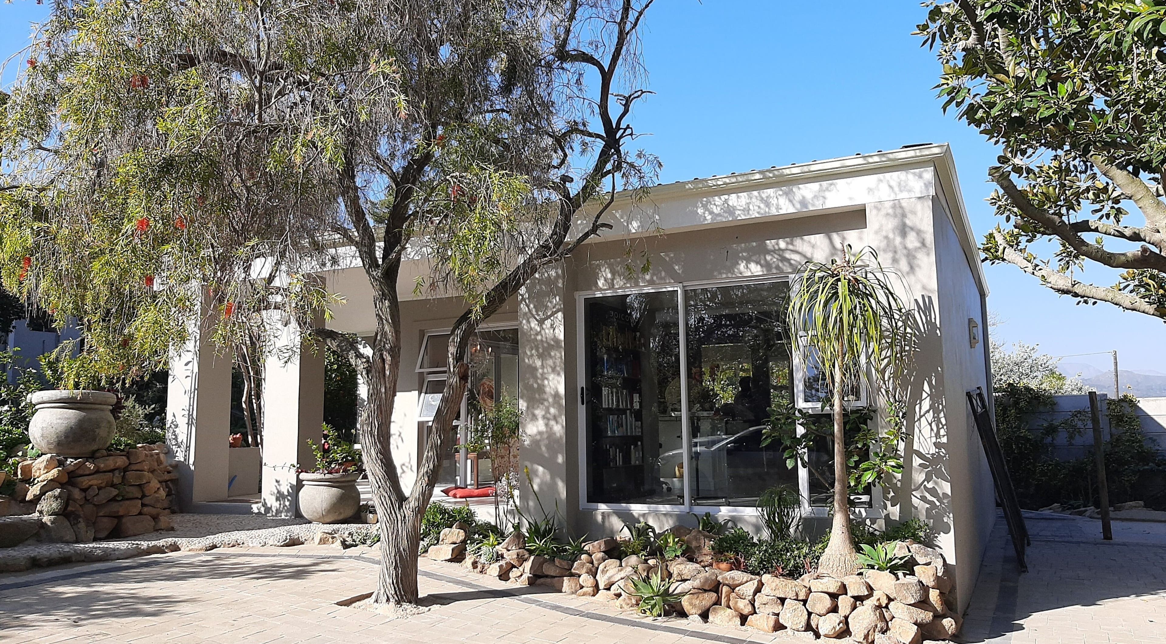Relaxing exterior of Sherri Styles at 134 Upper Orange, Somerset West, Western Cape, ZA surrounded by lush greenery.