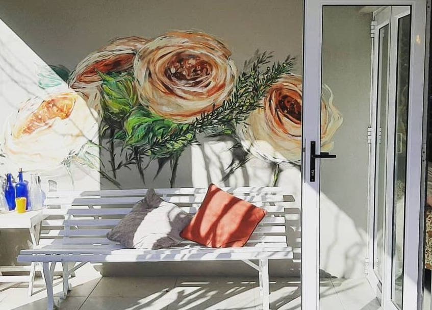Serene floral mural at Sherri Styles at 134 Upper Orange, Somerset West, Western Cape, ZA with white bench seating.