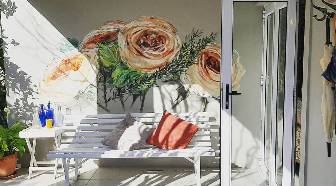 Serene floral mural at Sherri Styles at 134 Upper Orange, Somerset West, Western Cape, ZA with white bench seating.
