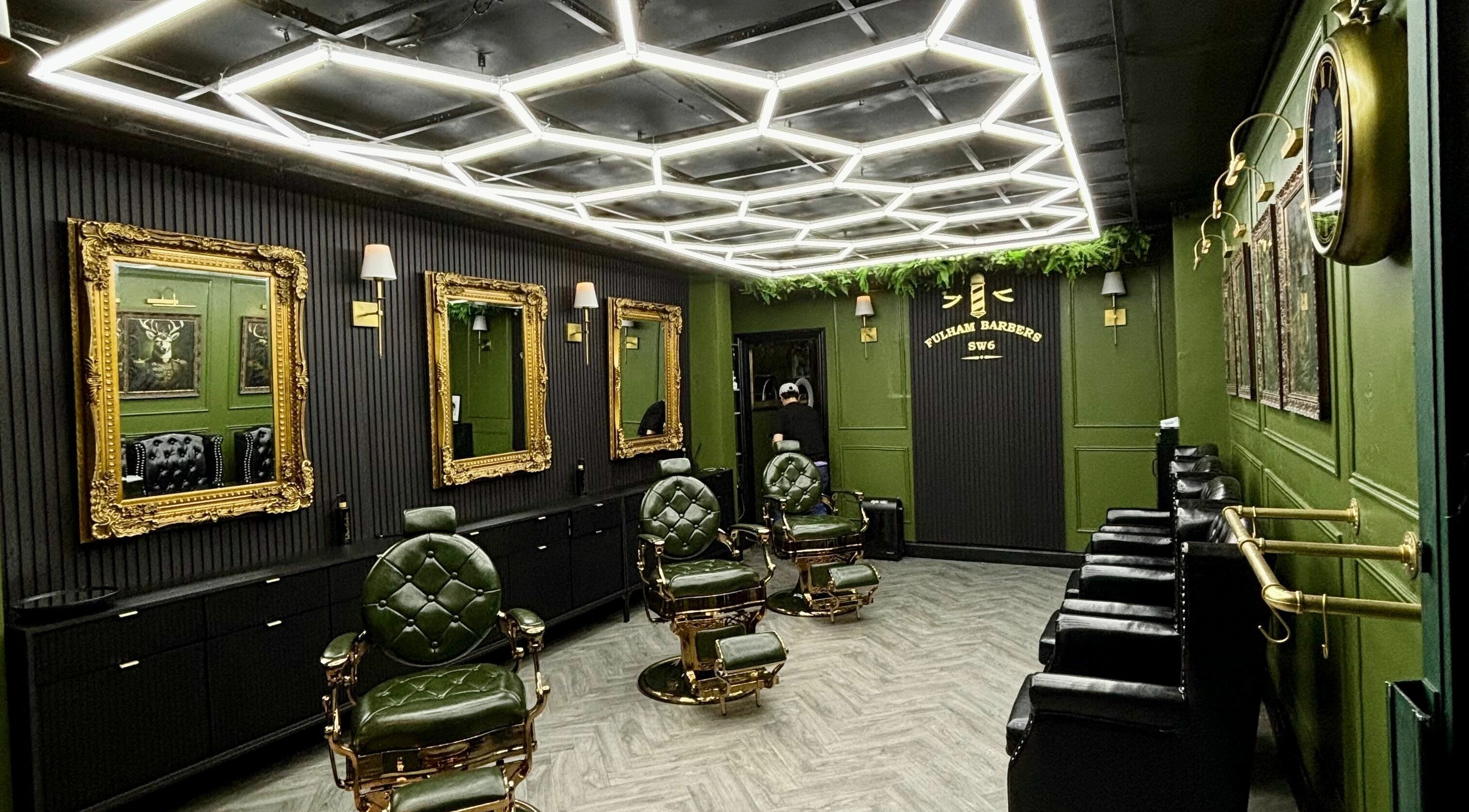 Luxurious interior of Fulham Barbers in London, England, GB showcasing vintage barber chairs and ornate decor.