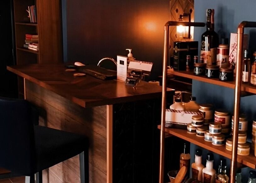 Warm, inviting interior of Prohibition Barber & Bourbon Room, Canmore, Alberta, CA, showcasing products and seating.