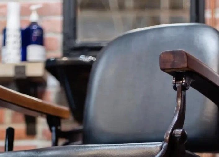 Classic barber chair at Prohibition Barber & Bourbon Room, Canmore, Alberta, CA showcasing vintage style.