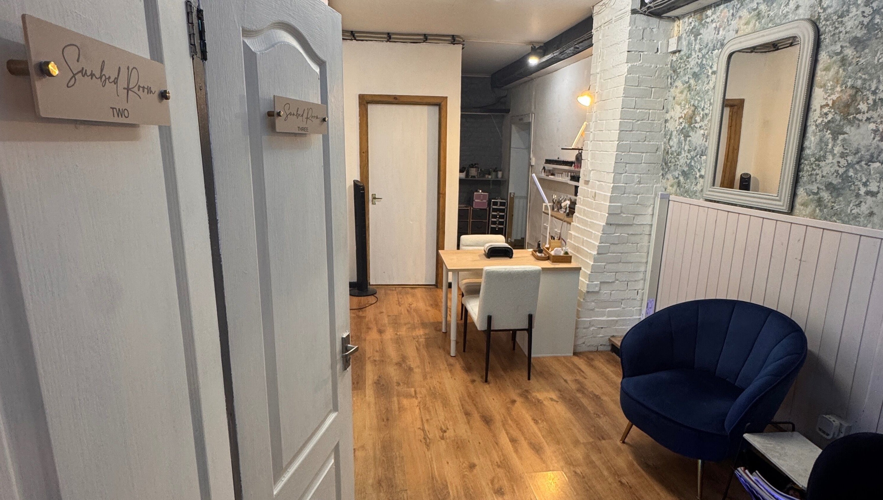 Cozy interior of Glo Tanning & Beauty Salon Newtown, Wales, GB with plush seating and inviting decor.